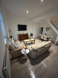 a living room with a couch and a table at Sandy Sunrise in Swansea