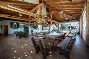 a large dining room with wooden tables and benches at Villa Vidonjica in Novalja