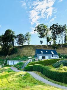 a house on the side of a hill with a road at Gåsviken - Hven in Sankt Ibb