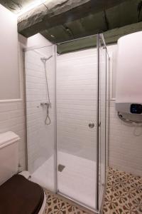 a shower with a glass door in a bathroom at Hospedería Monasterio de San Leandro in Seville +39 photos