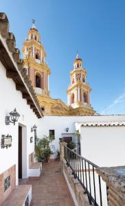a view of a church with two towers at Hospedería Monasterio de San Leandro in Seville
