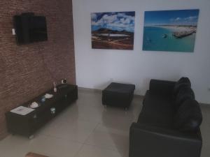 a living room with a couch and a table at Apartamento T1 Mobilado Espargos/Sal in Espargos