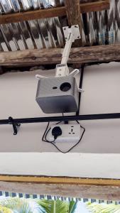a speaker hanging from the ceiling of a room at Tropical Paje Home with Pool Near the Beach in Paje