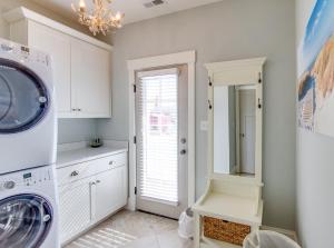 a white laundry room with a washer and dryer at 410B The King Neptune House in Virginia Beach