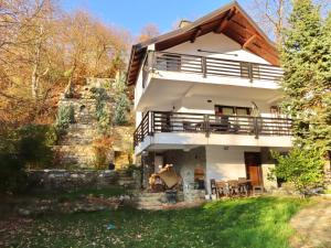 a large white house with a porch and stairs at Chez Vila in Prizren