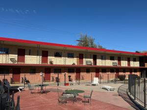 a building with tables and chairs in a courtyard at Springs Inn by Capital O I 25 in Colorado Springs