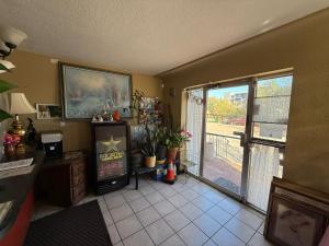 a living room with a large sliding glass door at Springs Inn by Capital O I 25 in Colorado Springs