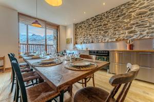 a dining room with a large wooden table and chairs at Chalet des Granges in Saint-Marcel +66 photos