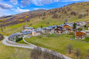 a village on a hill with a road at Chalet des Granges in Saint-Marcel