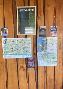 a wall with signs on a wooden wall at La cascada in Futaleufú
