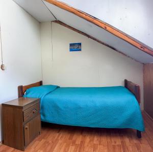 a bedroom with a bed and a wooden dresser at La cascada in Futaleufú