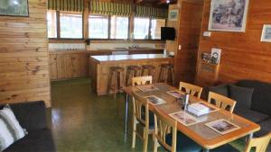 uma sala de jantar com uma mesa e um bar em Gunyah Valley Retreat em Goornong