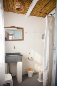 a bathroom with a sink and a toilet at Carmela Suites Cabo Polonio in Cabo Polonio