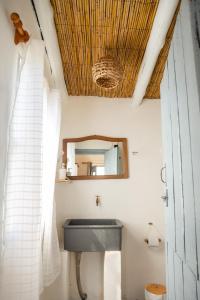 a bathroom with a sink and a mirror at Carmela Suites Cabo Polonio in Cabo Polonio