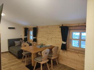 a living room with a table and chairs and a couch at Zeffereralm in Forstau