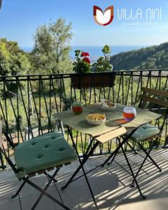 a table and two chairs sitting on a balcony at Villa Nini' Exclusive Nature by ElodeaGroup in Pellezzano