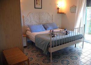 a bedroom with a bed with blue pillows at Villa Nini' Exclusive Nature by ElodeaGroup in Pellezzano