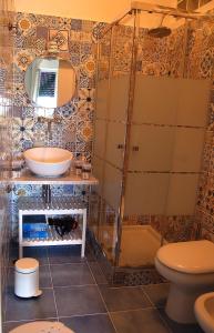 a bathroom with a shower and a sink and a toilet at Villa Nini' Exclusive Nature by ElodeaGroup in Pellezzano