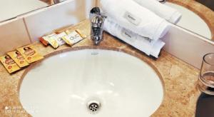 a bathroom sink with a faucet and towels on it at Departamentos de Altura in Tarija