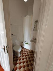 a small bathroom with a toilet and a sink at Mirasol Guesthouse in Funchal