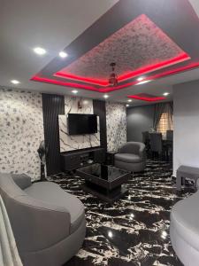 a room with couches and a flat screen tv at GG suites and Apartments in Owerri