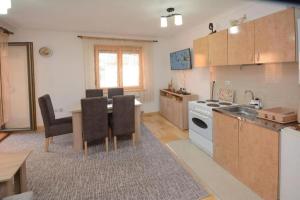 a kitchen with a table and a dining room at Center 4U in Vrnjačka Banja