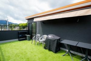 a patio with two chairs and a table and a grill at Tabiudo Stay Miyajima 01-02 - Vacation STAY 20513 in Fukae