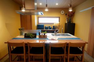 a kitchen with a kitchen island with a sink at Tabiudo Stay Miyajima 01-02 - Vacation STAY 20513 in Fukae