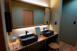 a bathroom with two sinks and a large mirror at Tabiudo Stay Miyajima 01-02 - Vacation STAY 20514 in Fukae