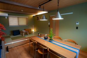 a kitchen with a long wooden table and chairs at Tabiudo Stay Miyajima 01-02 - Vacation STAY 20514 in Fukae