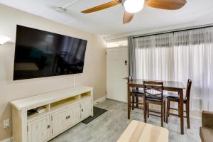 a living room with a dining room table and a flat screen tv at Wildwood Condo with Community Pool Walk to Beach! in Wildwood