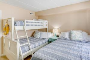 a bedroom with two bunk beds and a ladder at Wildwood Condo with Community Pool Walk to Beach! in Wildwood +18 photos