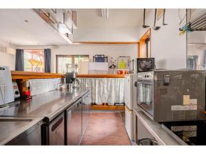 a kitchen with stainless steel counter tops in a kitchen at Easy Stay - Vacation STAY 20386 in Harada