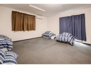two chairs in an empty room with a window at Easy Stay - Vacation STAY 20386 in Harada