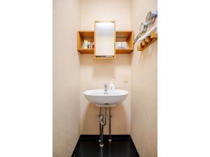 a bathroom with a sink and a mirror at Easy Stay - Vacation STAY 20386 in Harada +38 photos