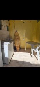 a room with a table and a bench and a barrel at Marea Home in Arraial do Cabo +4 photos