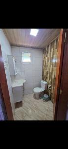 a bathroom with a toilet and a sink at Marea Home in Arraial do Cabo