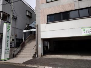 a building with stairs leading into a parking lot at Hotel Calm Place - Vacation STAY 69222v in Kanda +7 photos