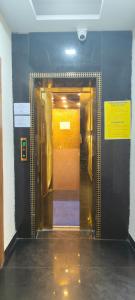 a hallway leading to a elevator in a building at Baghdad Palace Near Dargah sharif in Ajmer