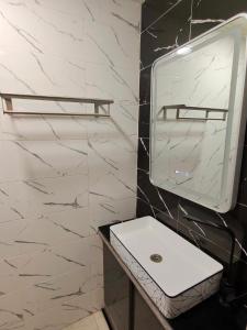 a bathroom with a white sink and a mirror at LH Appart in Afourer