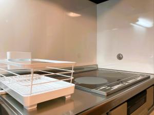 a kitchen with a stove and a counter top at Wakayama - House - Vacation STAY 64124v in Wakayama +51 photos