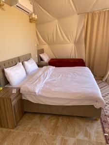 a bedroom with a bed in a tent at Lunara rum camp in Wadi Rum