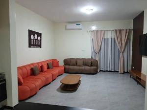 a living room with a couch and a table at Villa Standing Ngaparou in Ngaparou +9 photos