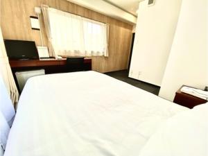 Un pat sau paturi într-o cameră la Hotel Calm Place - Vacation STAY 69240v