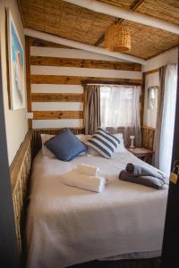 a bed in a room with two towels on it at Carmela Suites Cabo Polonio in Cabo Polonio
