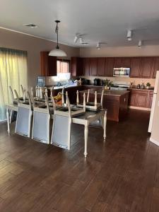 a dining room and kitchen with a table and chairs at West Valley Tiny Room Bennet in Phoenix