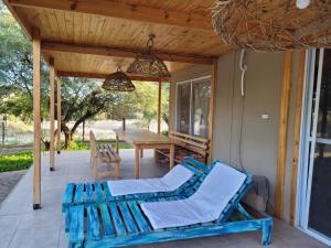 a patio with a table and chairs and a bench at CASA PARA 10 PERSONAS, CAFAYATE in Cafayate