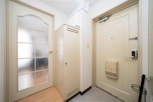 a hallway with a white door and a window at Nakajima Park Mansion - Vacation STAY 20417 in Toyohira +91 photos