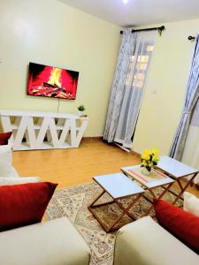a living room with a couch and a table at HERIJ Staycation kitengela in Kitengela 