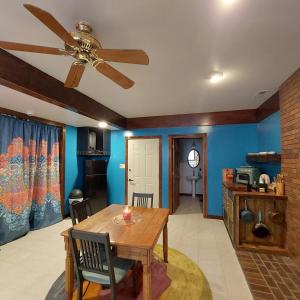 a dining room with a table and a ceiling fan at Cirque Stay in Lawrence